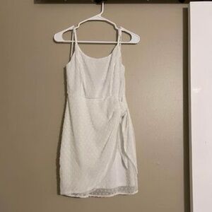 White lulus mid thigh dress. Size small. Tie knot on the side, scoop neck.